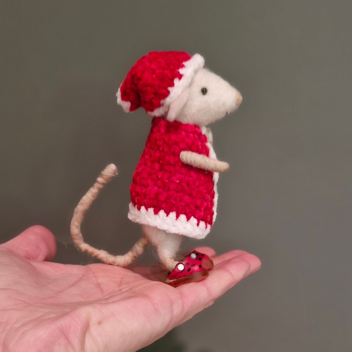 a needle felted mouse with a crochet cape. 